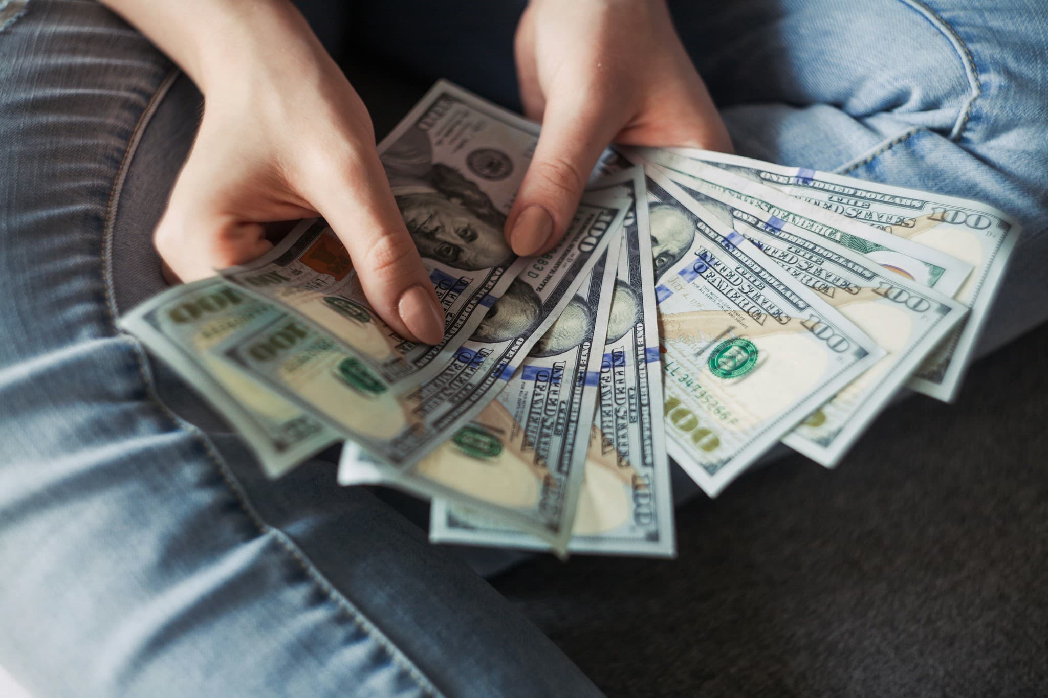 Person Holding Money - How To Build A Shopify Store