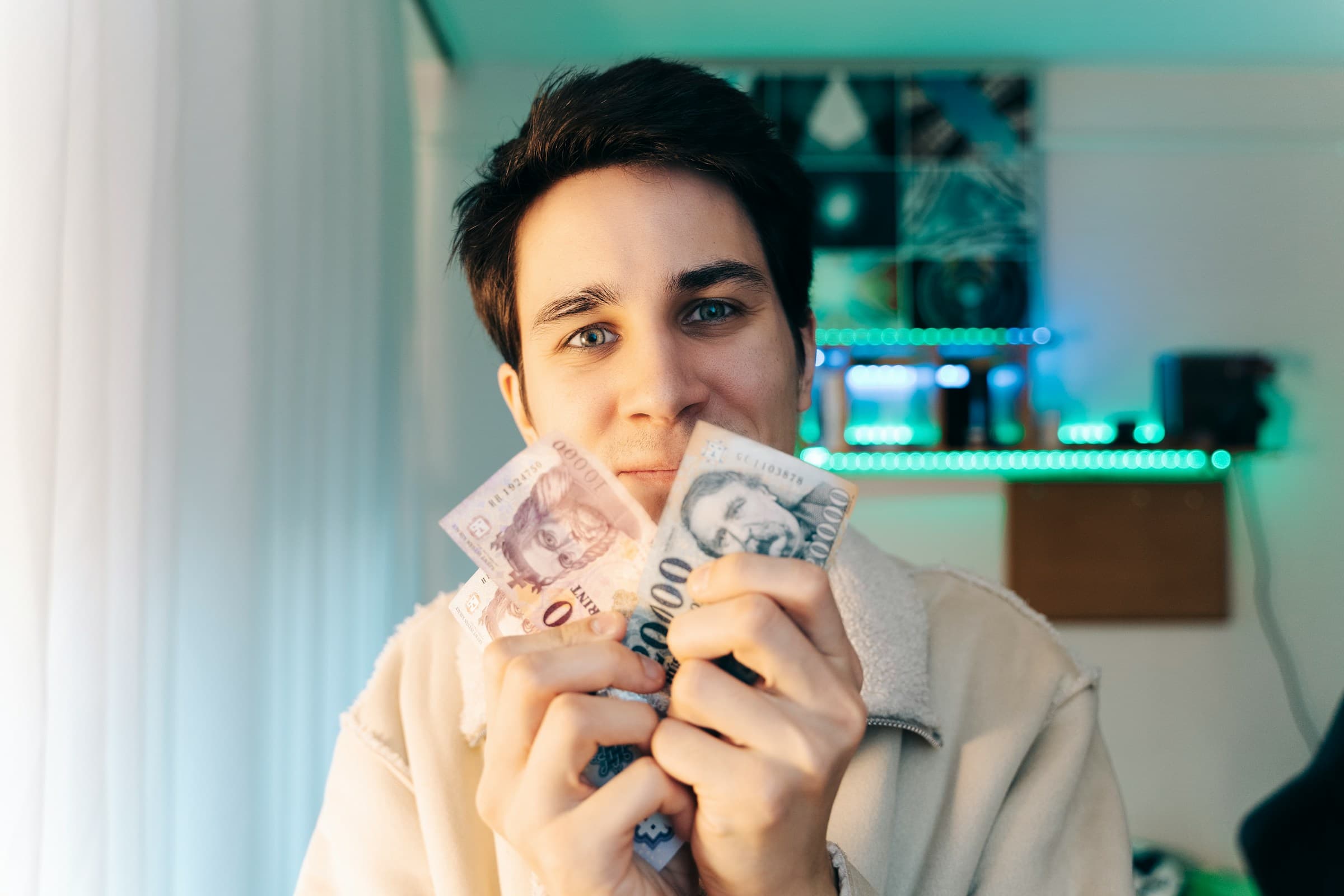 man holding money - How Much Does It Cost to Build a Shopify Website