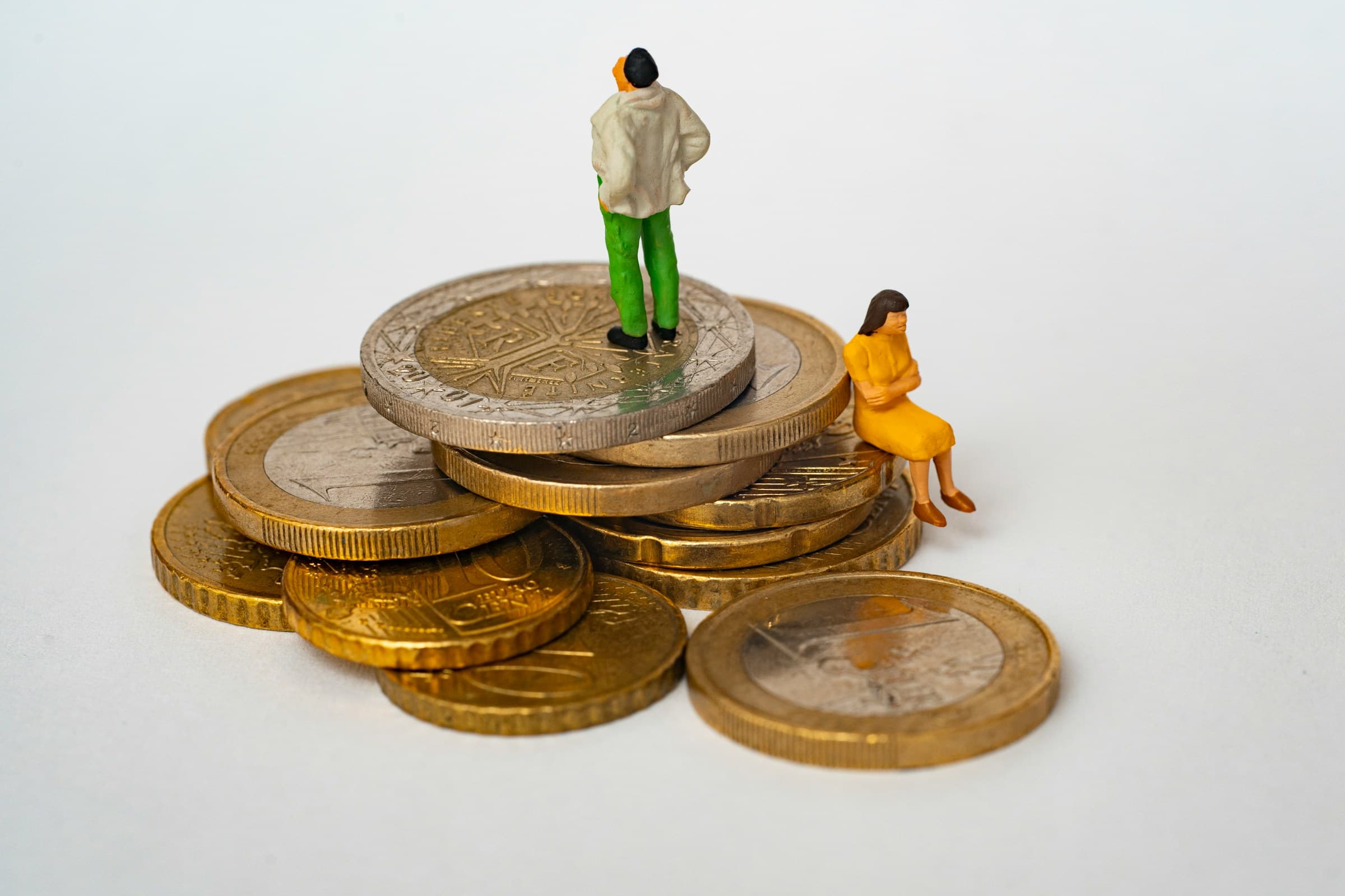 person standing on coins - How Much Does It Cost to Build a Shopify Website