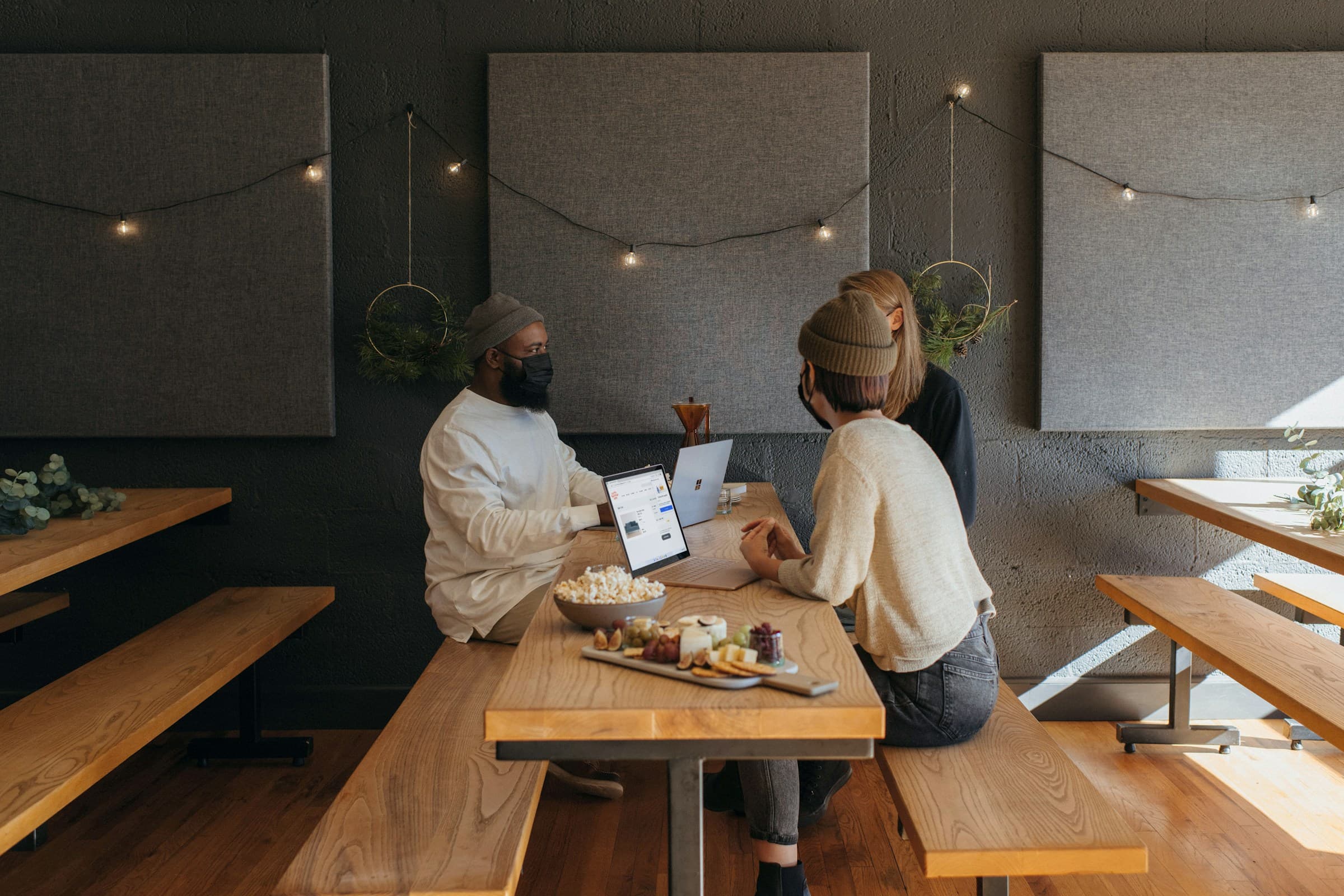 person sitting on bench with friends - Shopify Landing Pages
